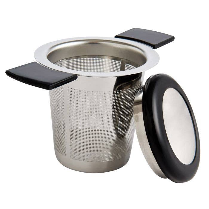 Stainless steel tea infuser with black handles on a white background